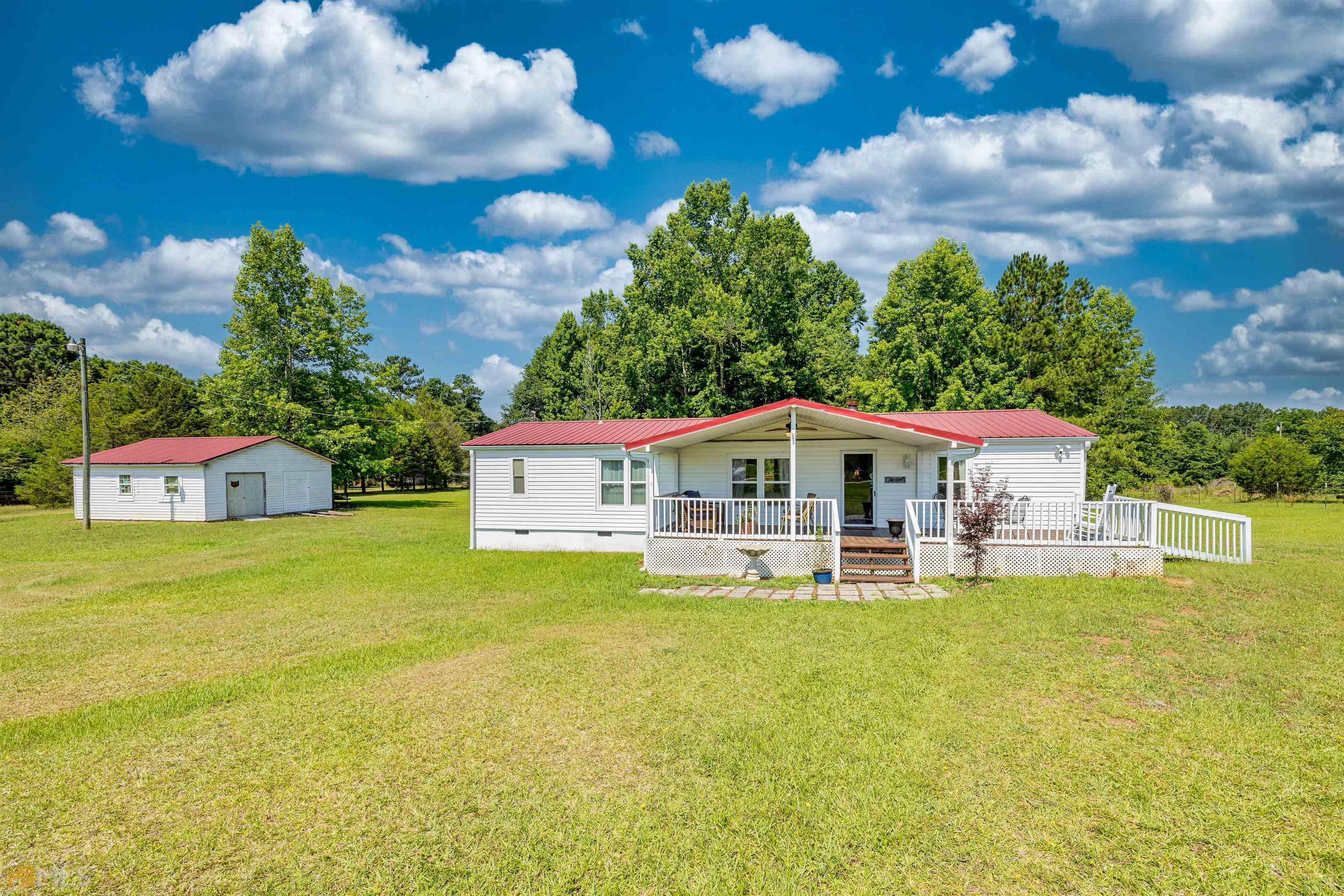 560 Cook Road Griffin, GA 30224 - Photo 1 of 1 a front view of a house with a garden and deck