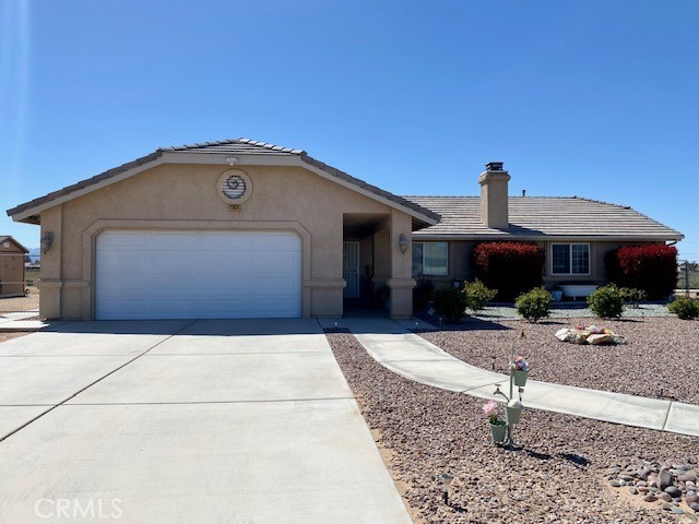 11074 Katchina Road Apple Valley, CA 92308 - Photo 1 of 1 a front view of a house with garden