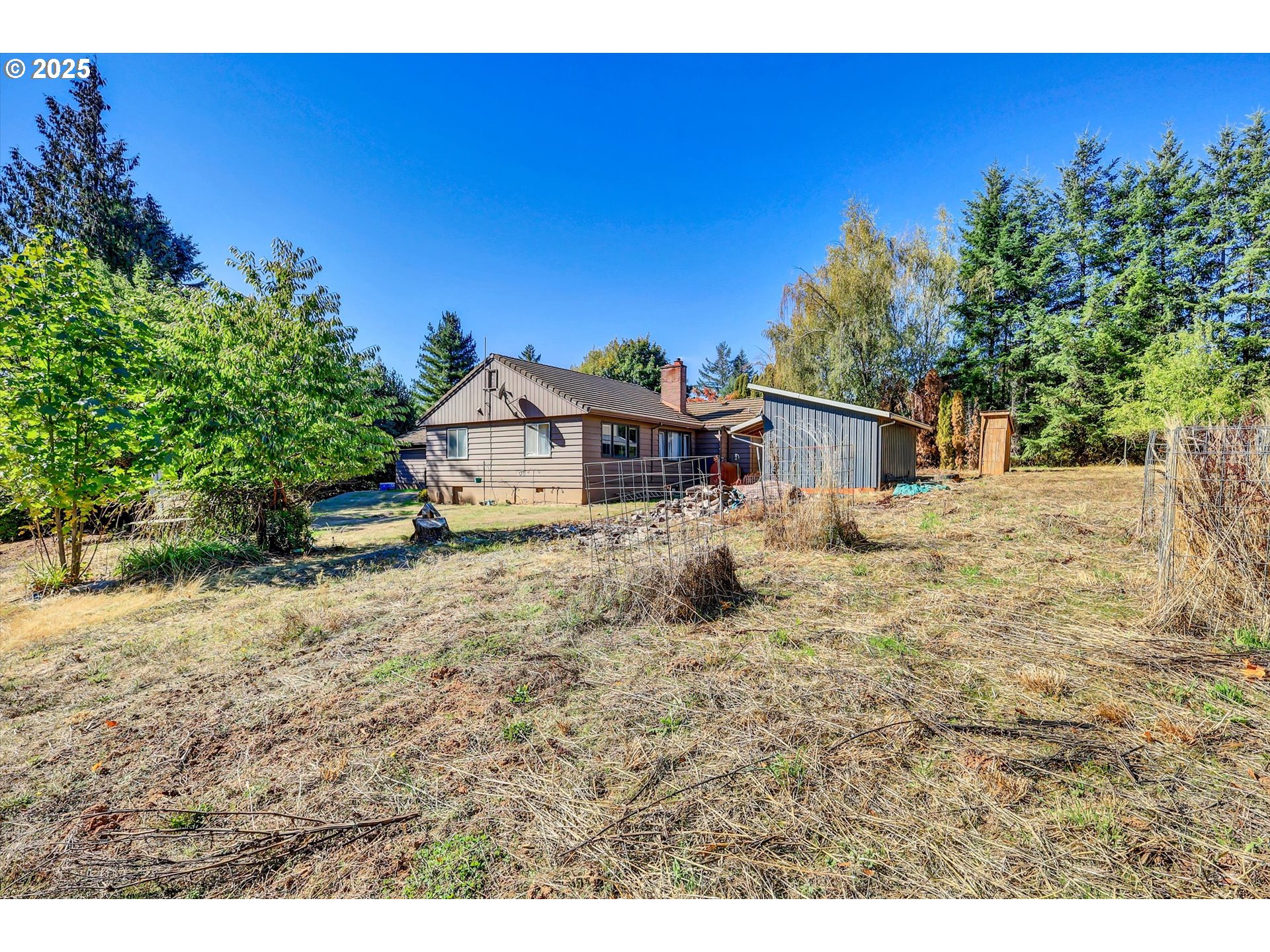 21076 Northwest Green Mountain Road Banks, OR 97106 - Photo 20 of 46 a house view with a wooden fence and a trees
