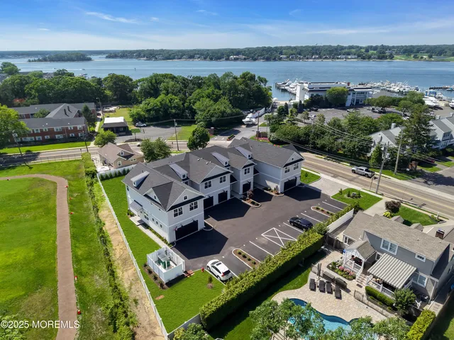 an aerial view of a house with outdoor space swimming pool and lake view