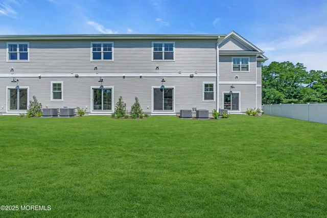 a front view of a house with yard and green space