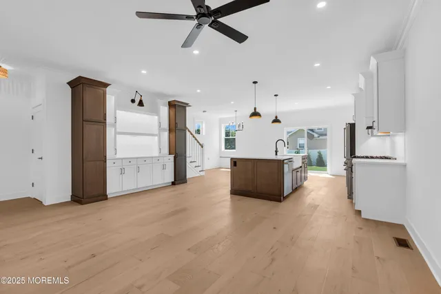 a view of a kitchen with white cabinets