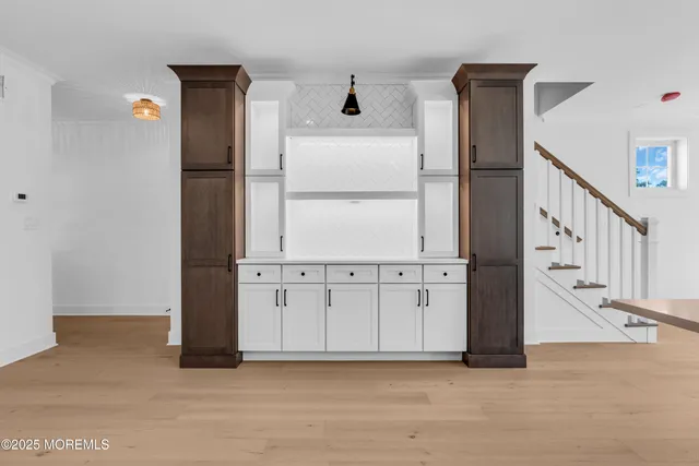 a view of a kitchen with a sink and a refrigerator