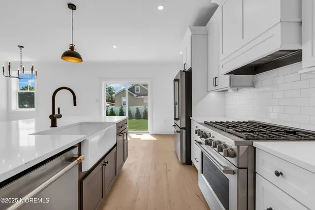 a kitchen with stainless steel appliances a sink stove and cabinets