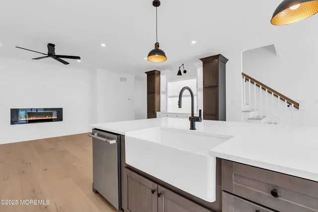 a kitchen with stainless steel appliances a sink a counter top space cabinets and a window