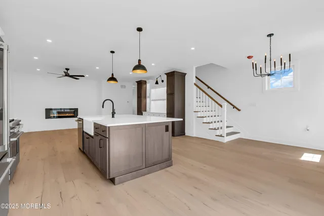 a kitchen with stainless steel appliances a refrigerator stove and cabinets