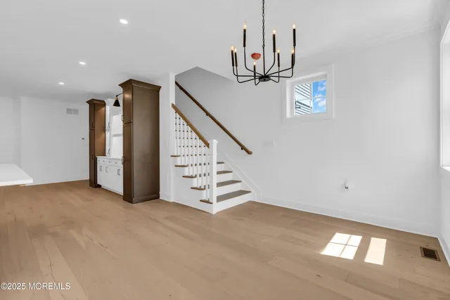 an empty room with window and ceiling fan