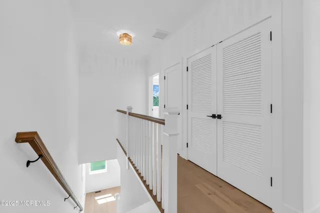 a bathroom with a toilet a sink a mirror and vanity