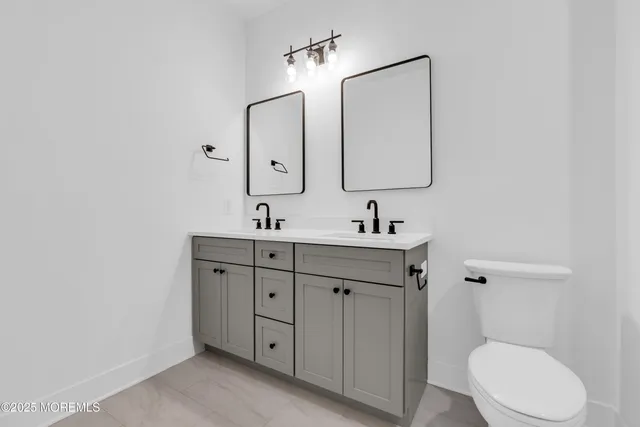 an empty room with closet and windows