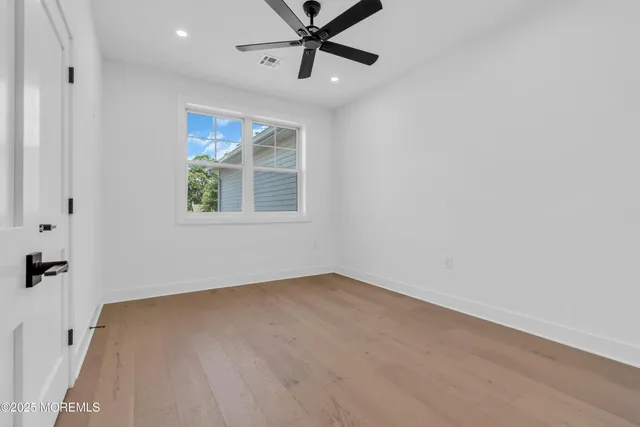 a bathroom with a granite countertop double vanity sink and a mirror