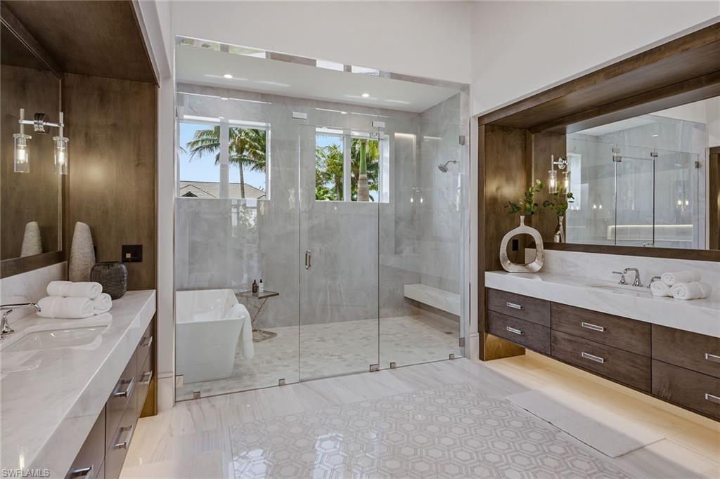 529 Neapolitan Way Naples, FL 34103 - Photo 14 of 26 a bathroom with a sink a toilet and shower