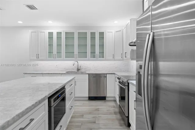 a kitchen with a stove and a sink