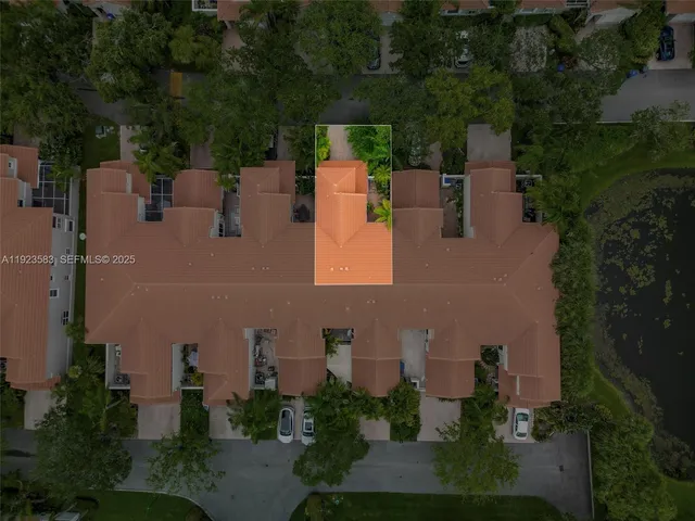 an aerial view of a houses with a lake view
