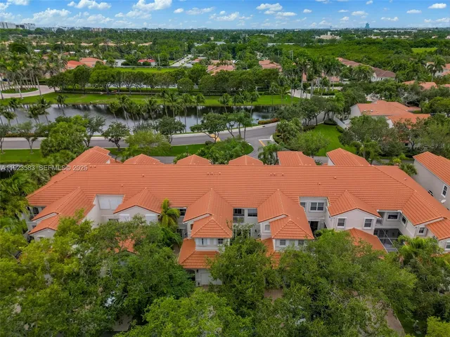 an aerial view of residential houses with outdoor space and river