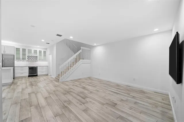 a large kitchen with kitchen island a sink stainless steel appliances and cabinets