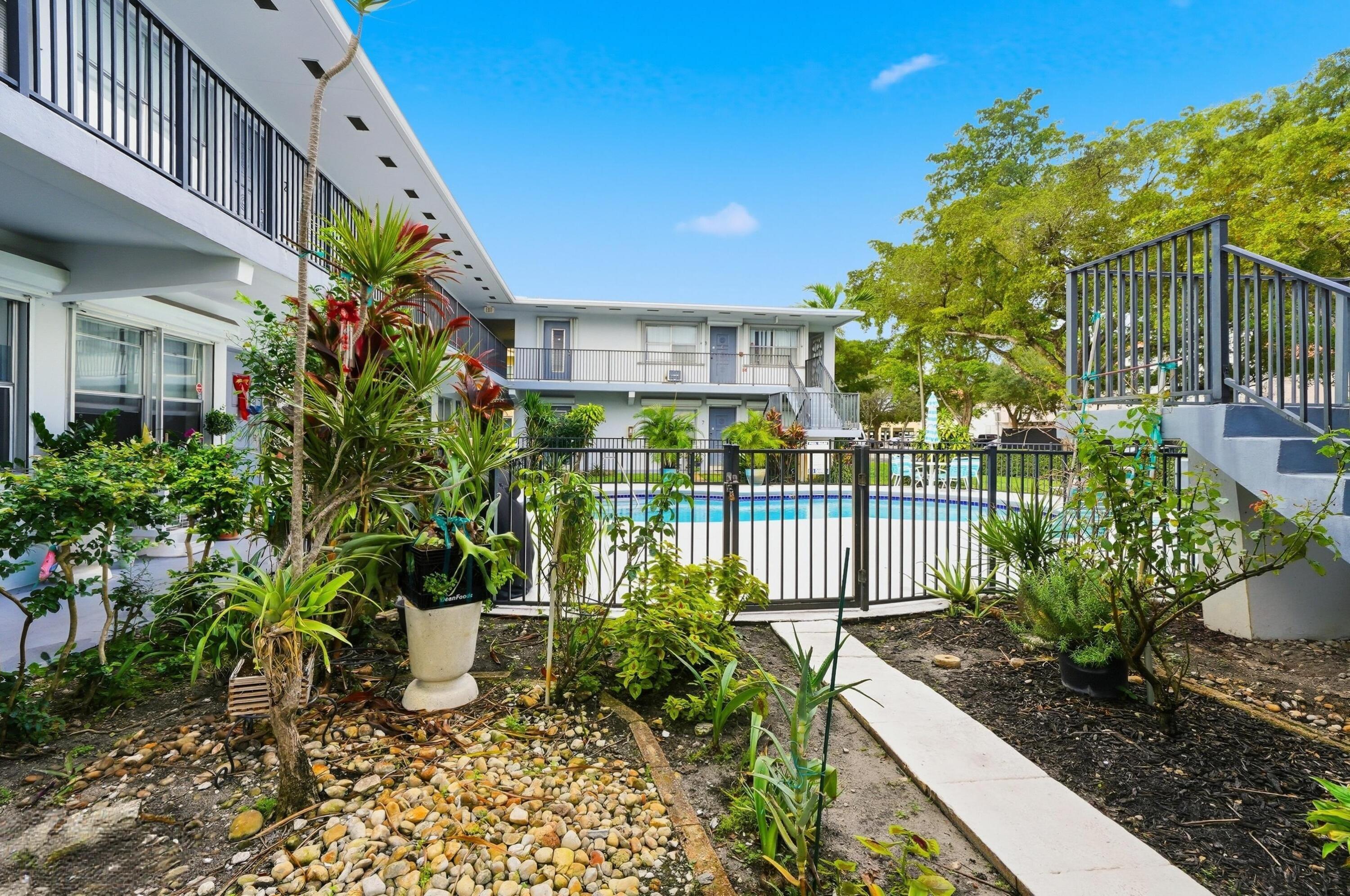 3510 Harrison Street, Unit 4 Hollywood, FL 33021 - Photo 3 of 31 a view of a house with a flower garden