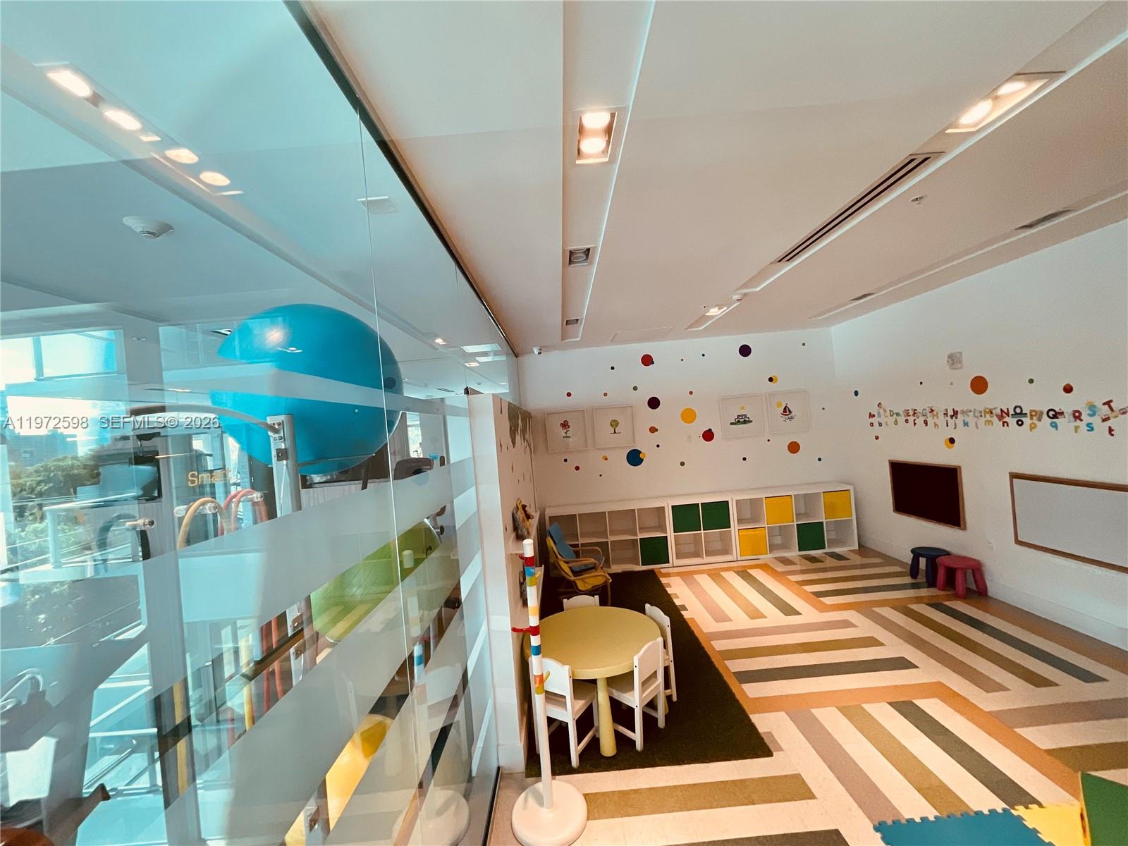 1600 Southwest 1st Avenue, Unit 1204 Miami, FL 33129 - Photo 22 of 75 a room with lots of white furniture and chandelier