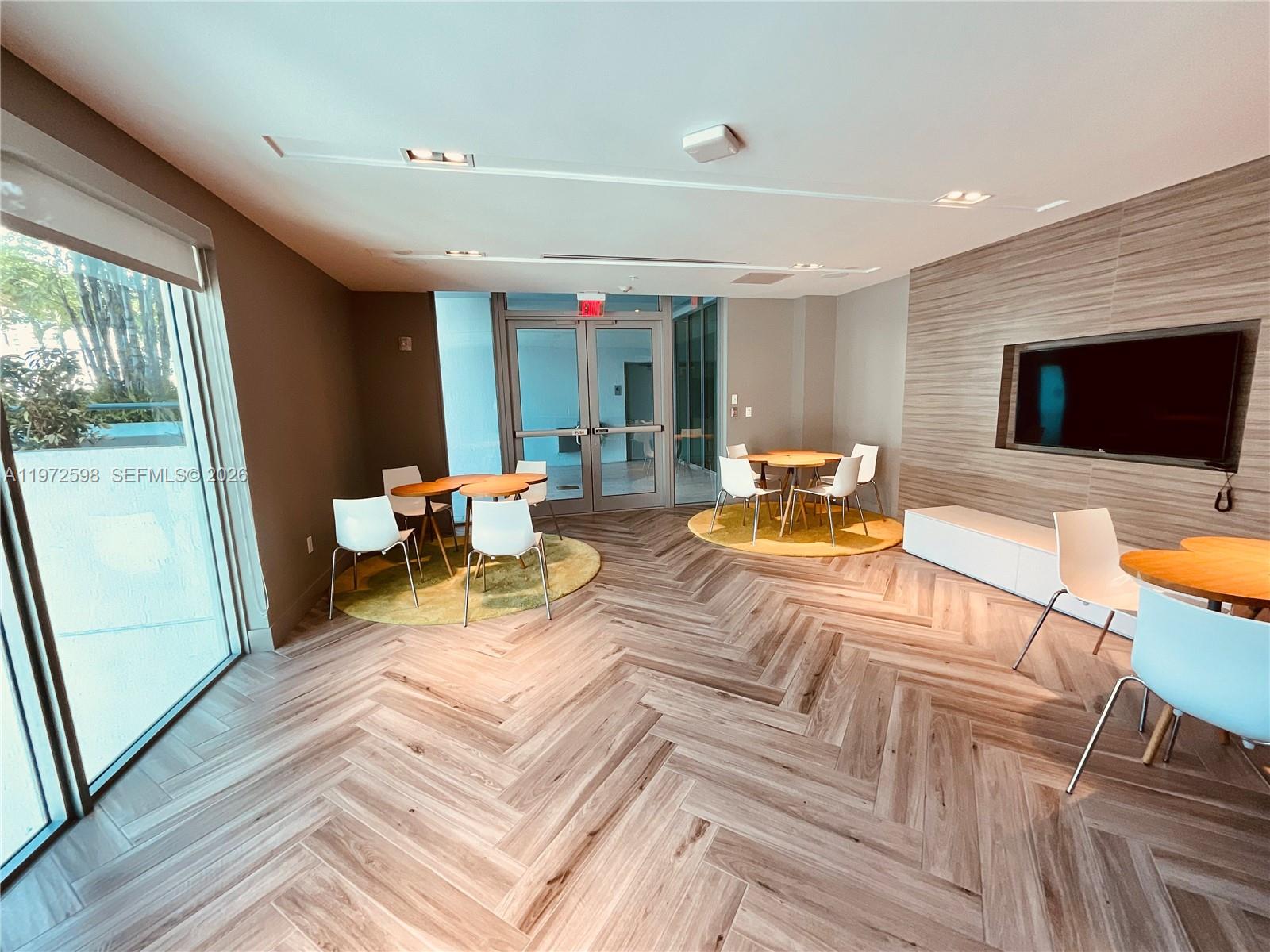 1600 Southwest 1st Avenue, Unit 1204 Miami, FL 33129 - Photo 23 of 75 a living room with furniture and a flat screen tv