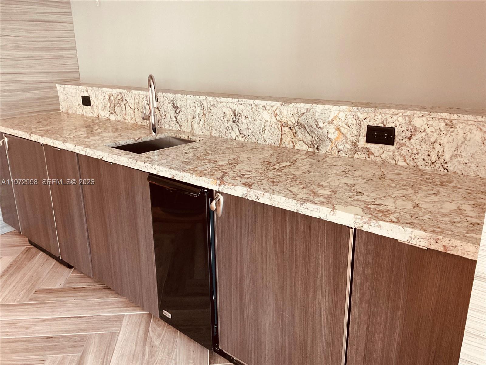 1600 Southwest 1st Avenue, Unit 1204 Miami, FL 33129 - Photo 24 of 75 a bathroom with a granite countertop sink and a mirror