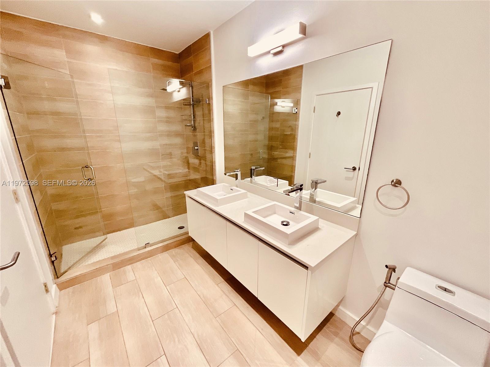 1600 Southwest 1st Avenue, Unit 1204 Miami, FL 33129 - Photo 53 of 75 a bathroom with a sink toilet and shower