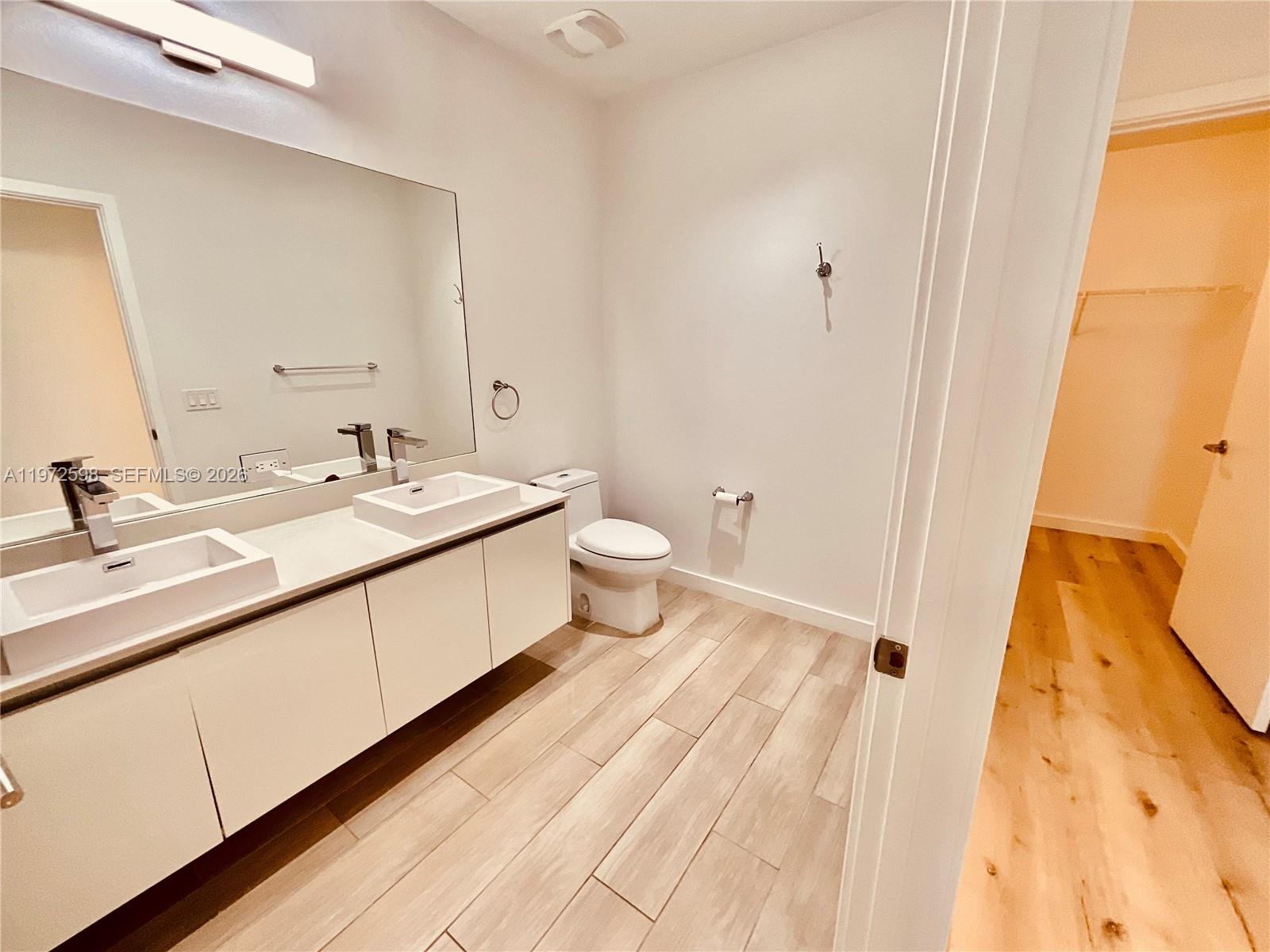 1600 Southwest 1st Avenue, Unit 1204 Miami, FL 33129 - Photo 54 of 75 a spacious bathroom with a double vanity sink and a mirror