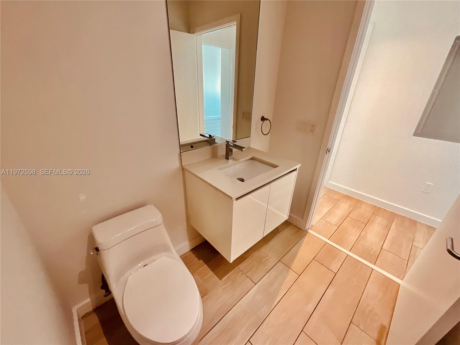 1600 Southwest 1st Avenue, Unit 1204 Miami, FL 33129 - Photo 57 of 75 a bathroom with a sink mirror and toilet