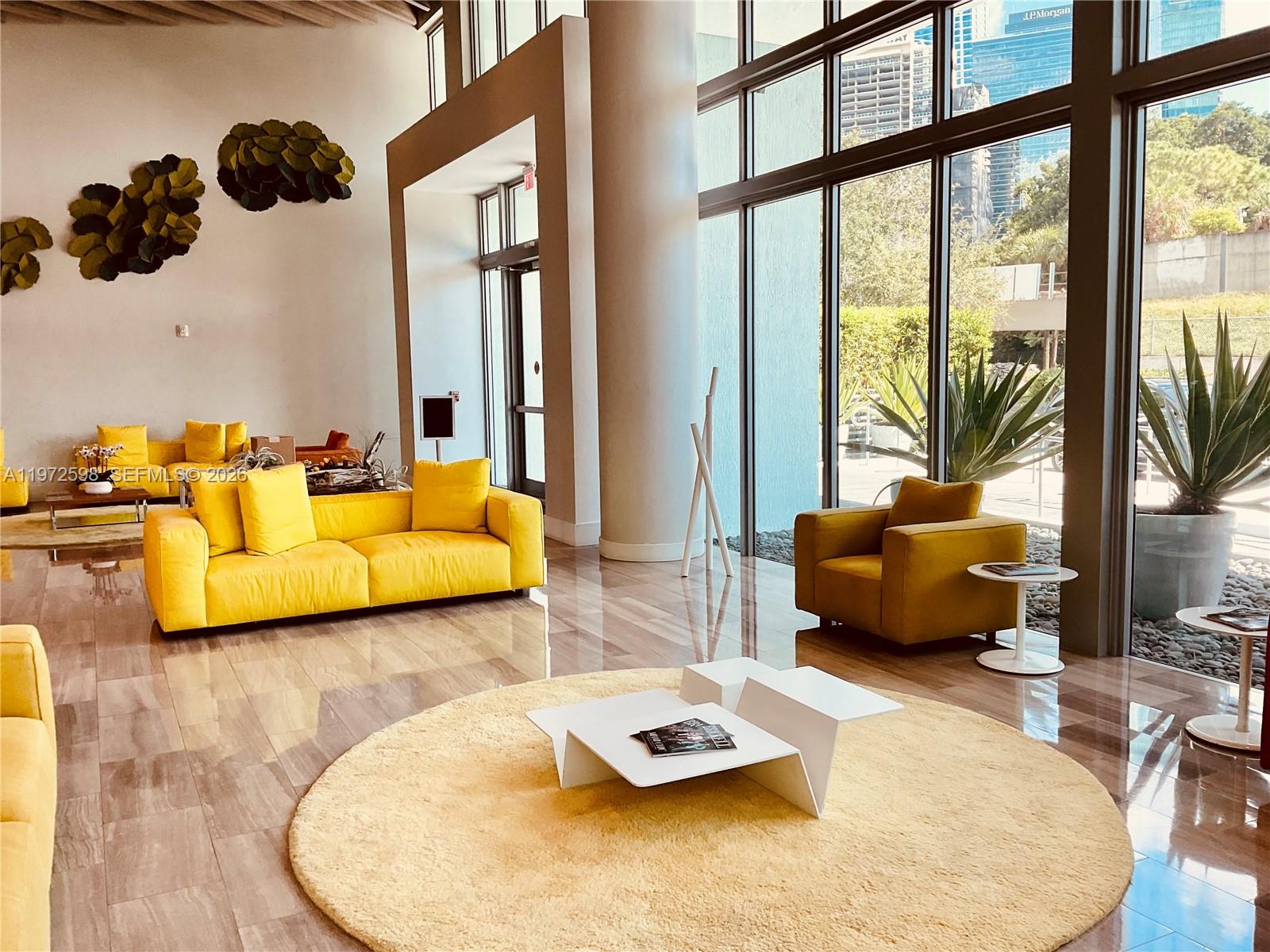 1600 Southwest 1st Avenue, Unit 1204 Miami, FL 33129 - Photo 6 of 75 a living room with furniture and a floor to ceiling window