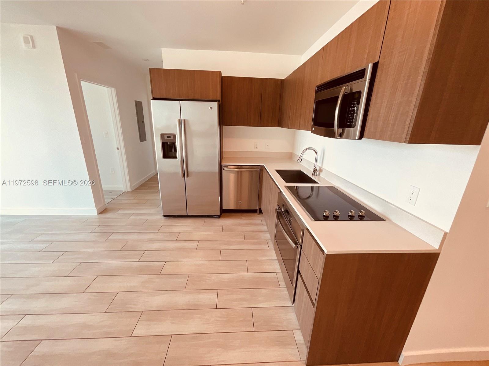 1600 Southwest 1st Avenue, Unit 1204 Miami, FL 33129 - Photo 63 of 75 a kitchen with stainless steel appliances a refrigerator a stove a microwave and a refrigerator
