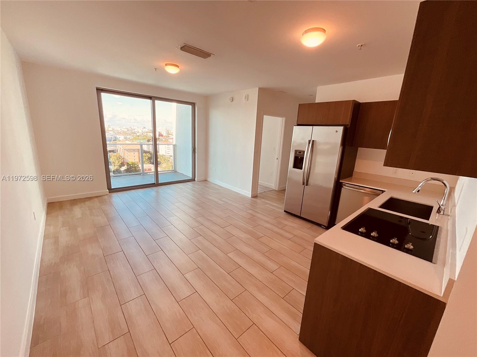 1600 Southwest 1st Avenue, Unit 1204 Miami, FL 33129 - Photo 64 of 75 a view of an empty room with a window and wooden floor