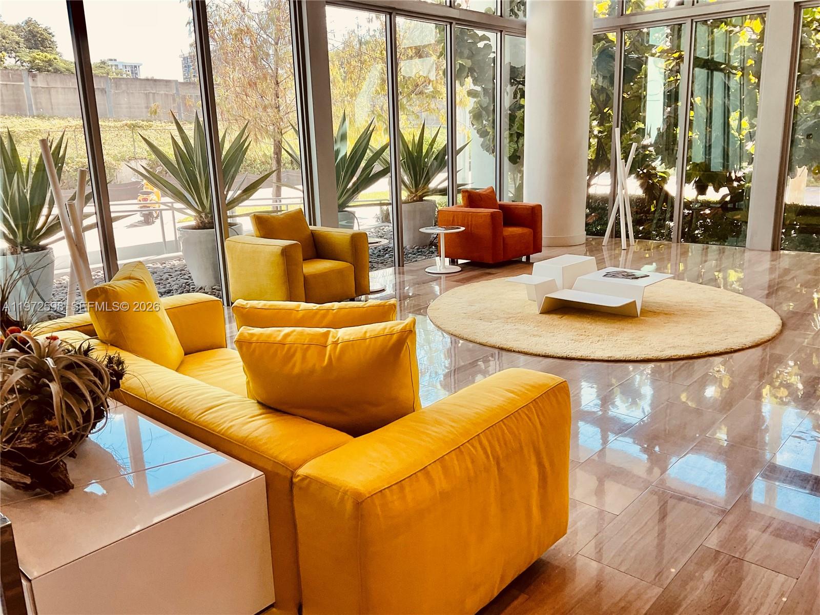 1600 Southwest 1st Avenue, Unit 1204 Miami, FL 33129 - Photo 7 of 75 a living room with a large window and a table