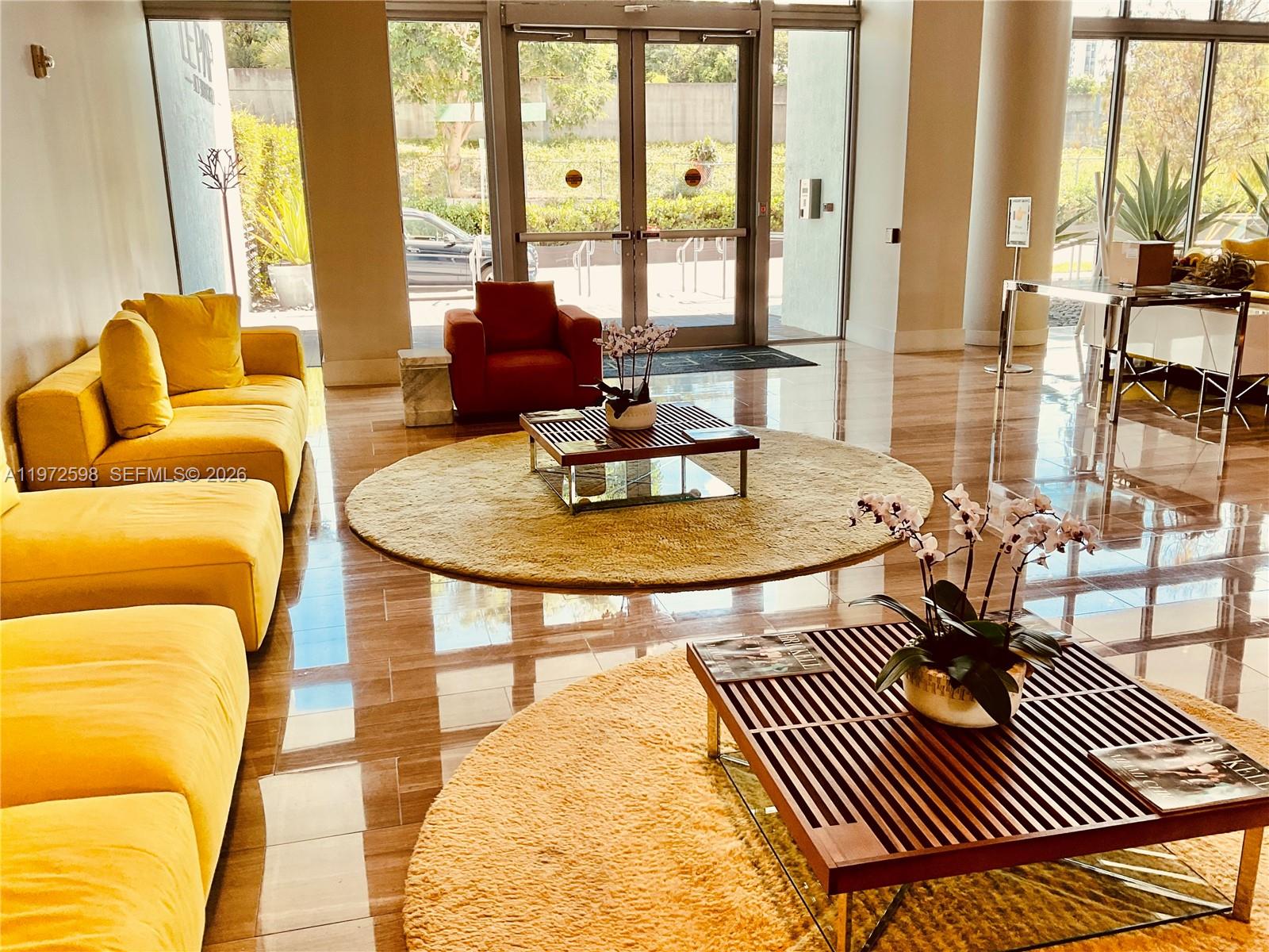 1600 Southwest 1st Avenue, Unit 1204 Miami, FL 33129 - Photo 10 of 75 a living room with a couch and wooden floor