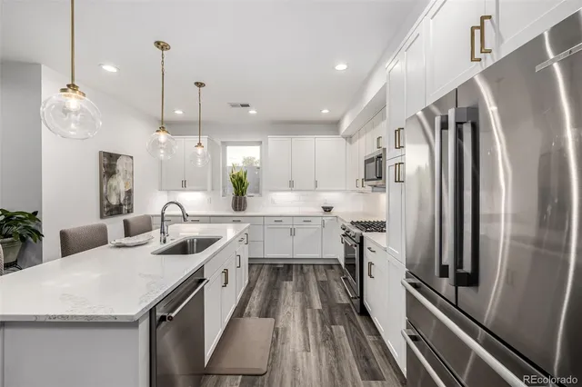 a kitchen with a table a sink and cabinets