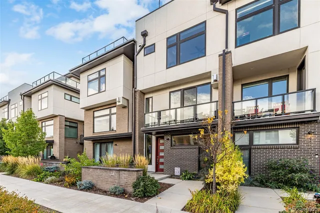 a front view of a residential apartment building with a yard