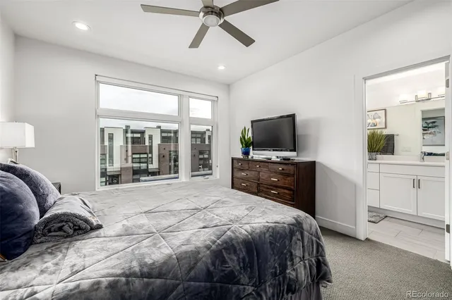 a bedroom with a bed and a lamp