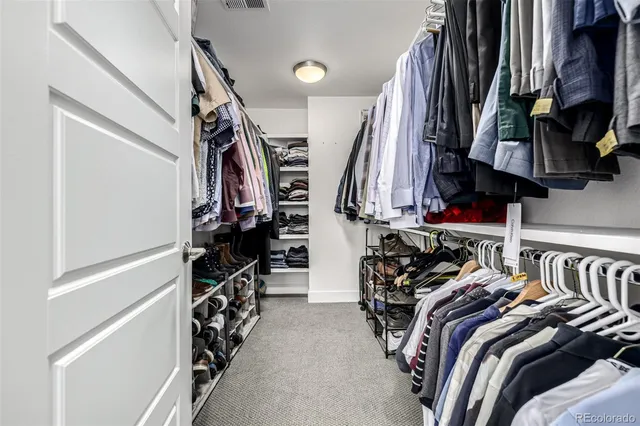 a bed room with a bed and a potted plant