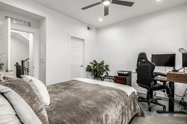 a bathroom with a granite countertop sink mirror vanity and toilet