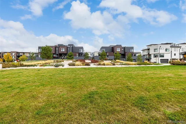 a view of a water fountain with a garden