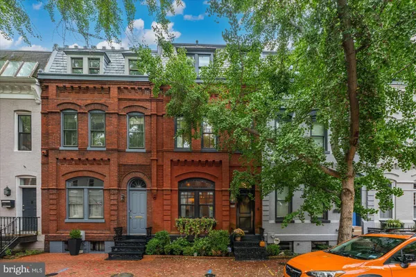 a front view of a residential apartment building with a yard
