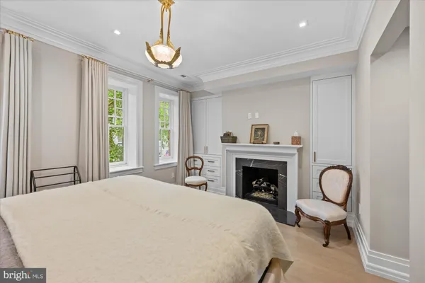 a bedroom with bed and a fireplace