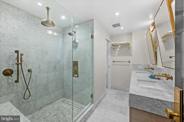 a bathroom with a shower sink and mirror