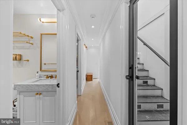 a view of a hallway with wooden floor and entryway