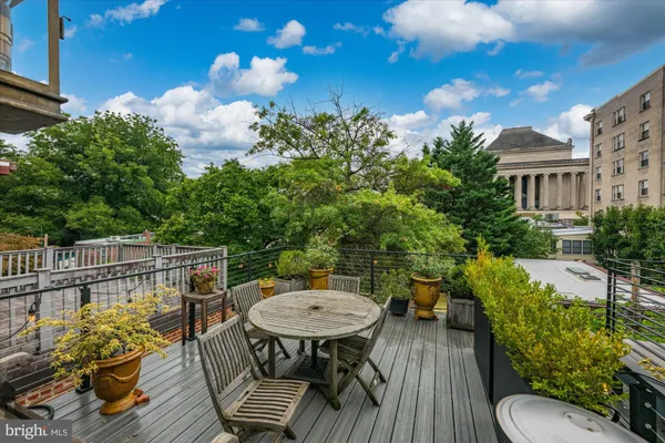 a view of a balcony with furniture and a potted plant