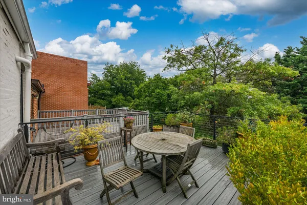 a view of balcony with wooden floor and outdoor seating