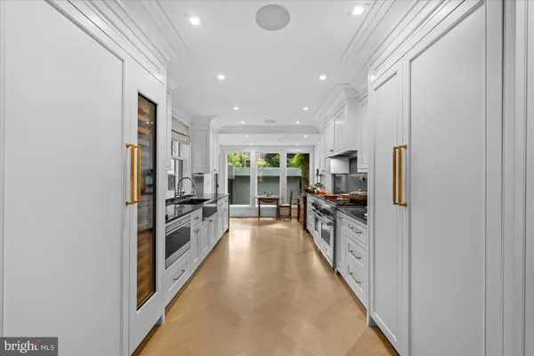 a large kitchen with a center island and stainless steel appliances