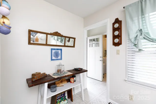 a view of a workspace with furniture and wooden floor