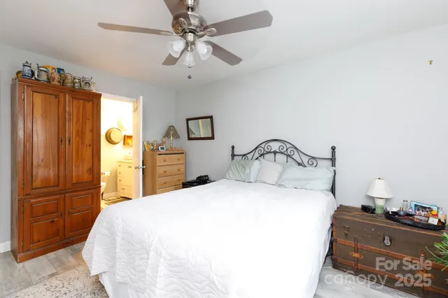 a bedroom with a bed and a mirror on the dresser