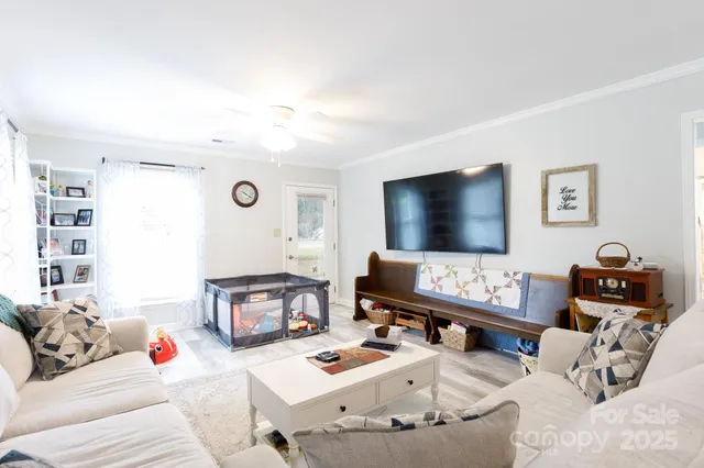 a living room with furniture and a flat screen tv