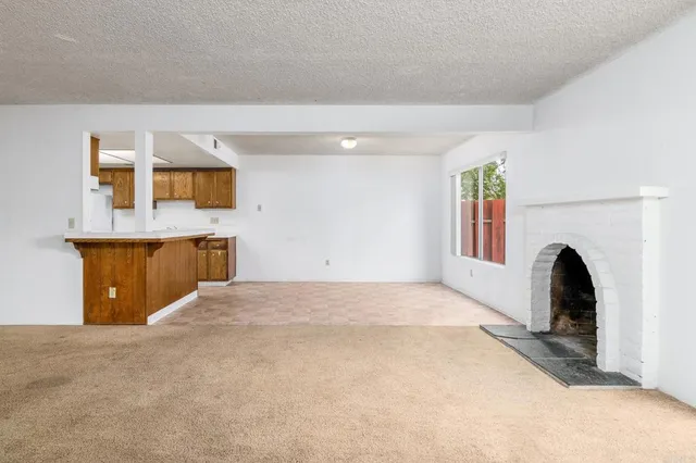 a kitchen with a sink a stove cabinets and wooden floor