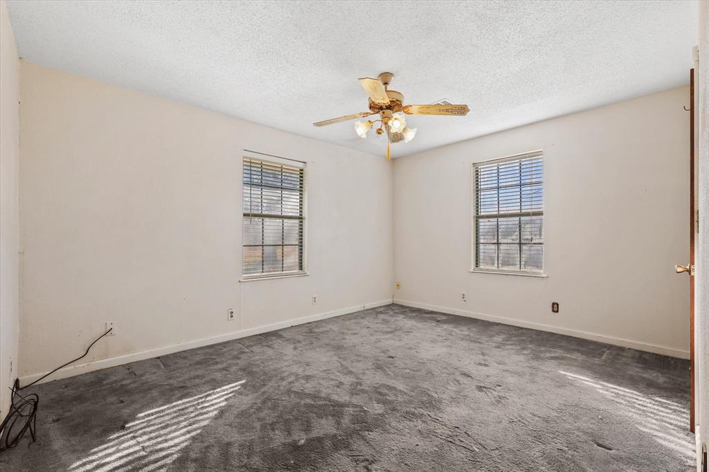 531 Private Road 4721 Rhome, TX 76078 - Photo 13 of 20 an empty room with windows and fan
