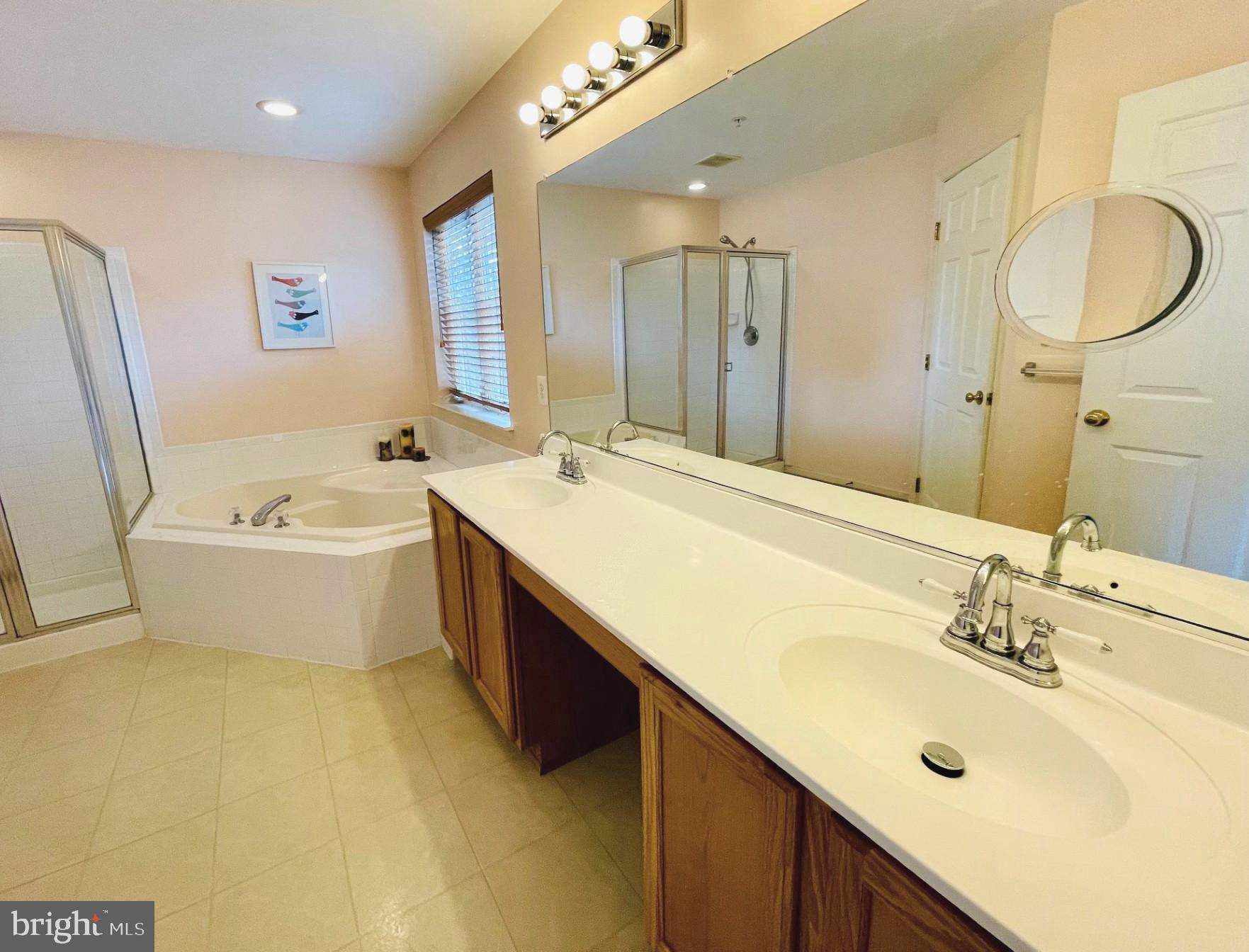 14613 Farnham Lane Laurel, MD 20707 - Photo 18 of 29 a bathroom with a double vanity sink mirror double vanity and bathtub